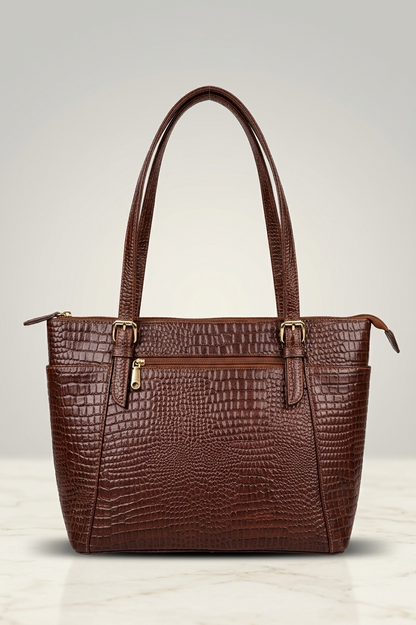 Brown handbag with crocodile pattern on a light background