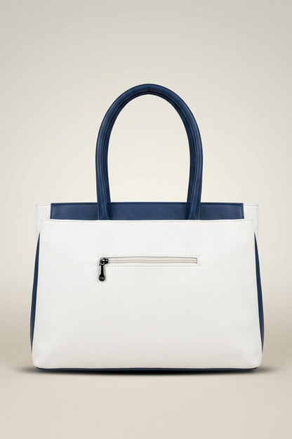 White handbag with navy accents on a beige background