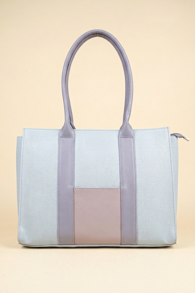 Light blue and pink tote bag on a beige background