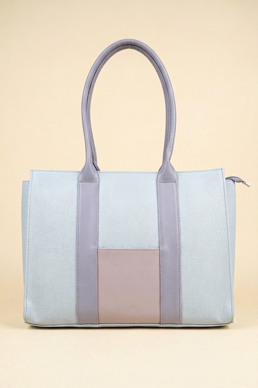 Light blue and pink tote bag on a beige background
